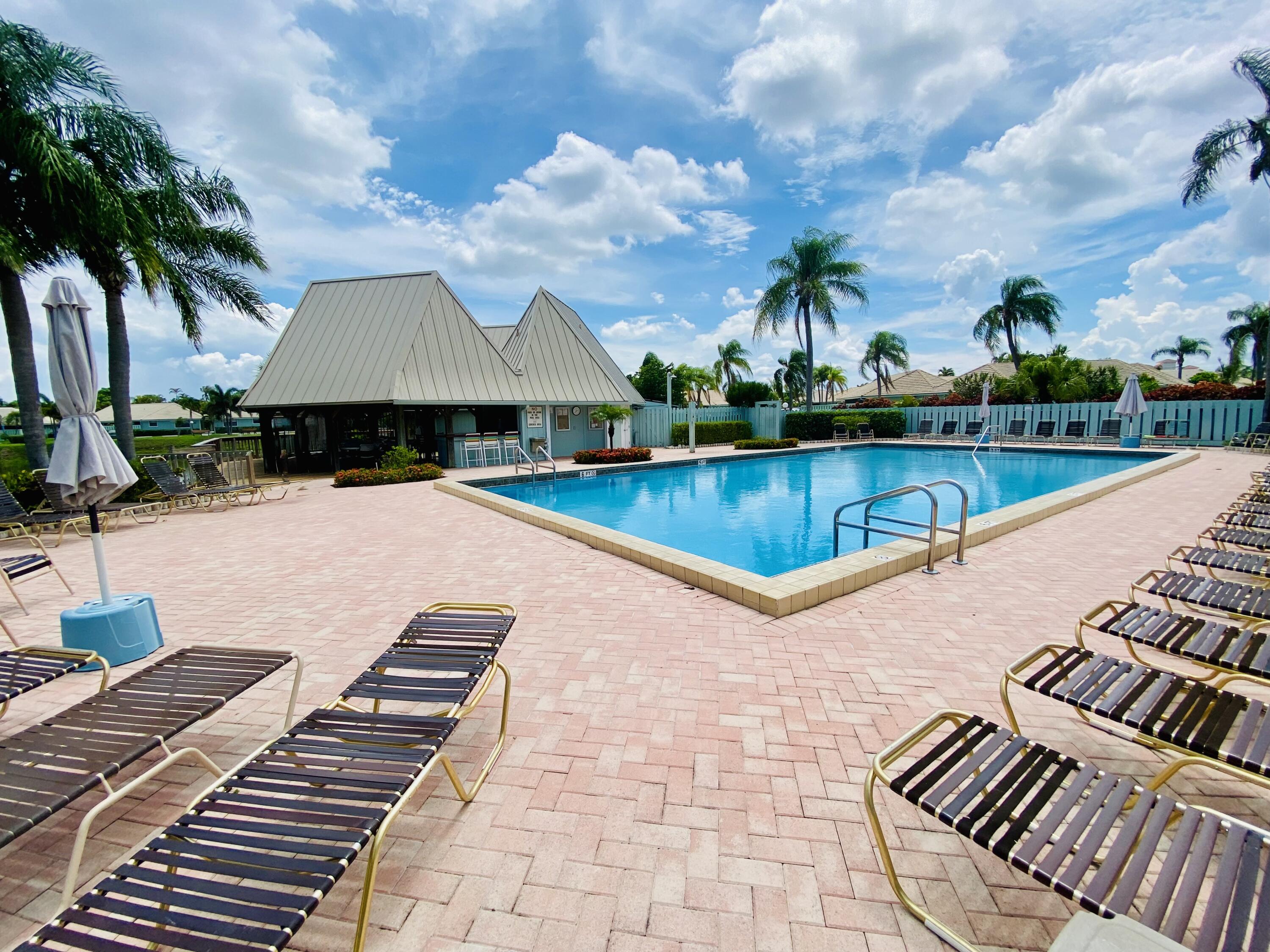 1127 East Seminole Avenue, Unit 13D Jupiter, FL 33477 - Photo 17 of 20 a view of swimming pool with lounge chair