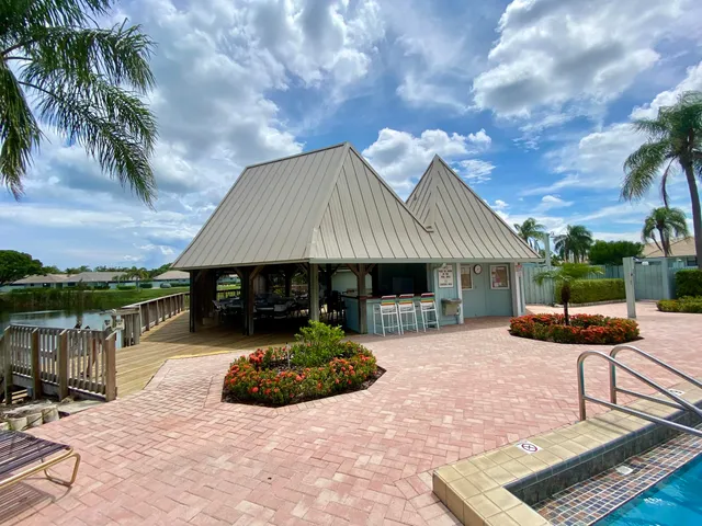 a front view of a house with garden and patio