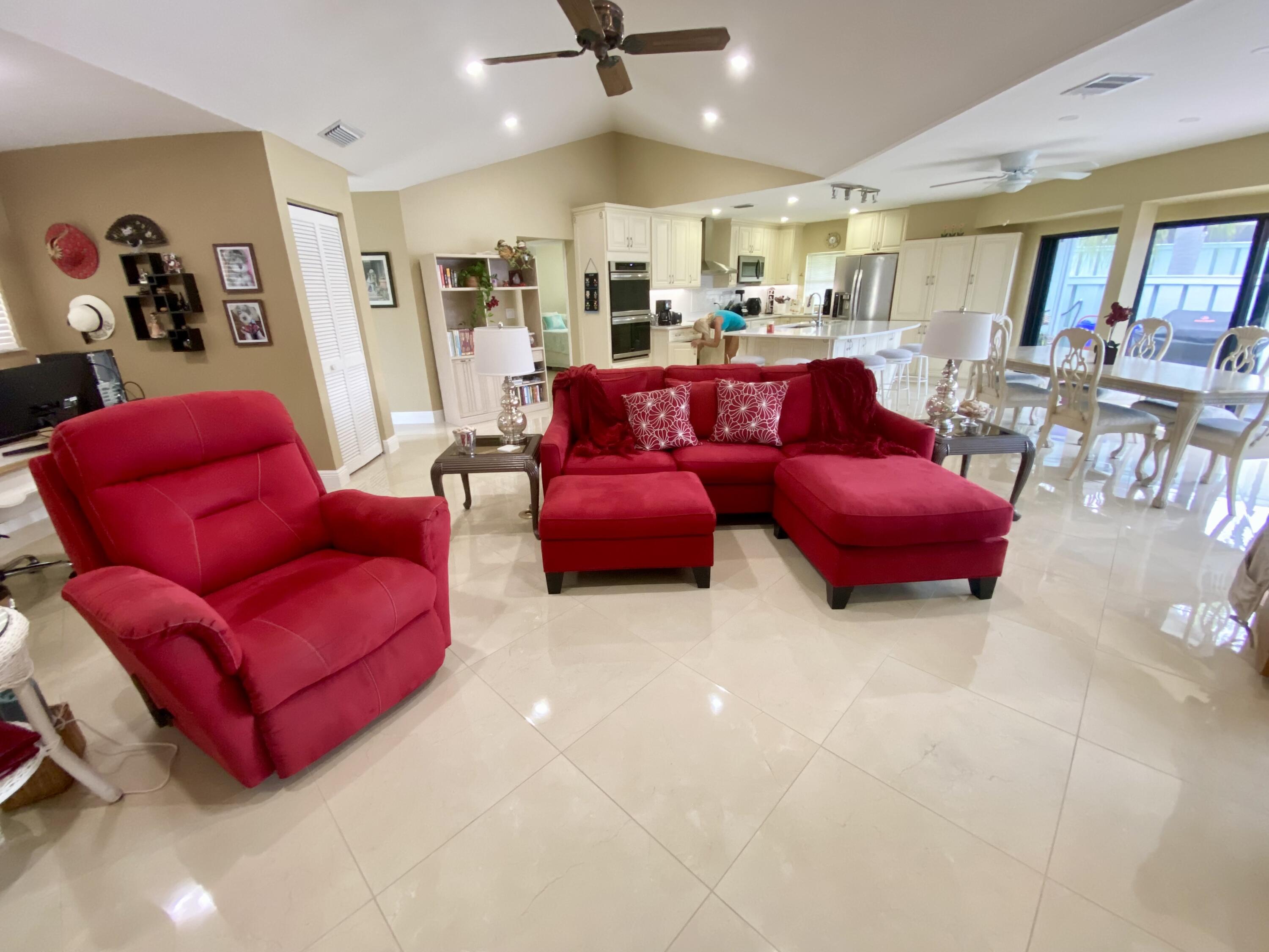 1127 East Seminole Avenue, Unit 13D Jupiter, FL 33477 - Photo 5 of 20 a living room with furniture kitchen view and a large window