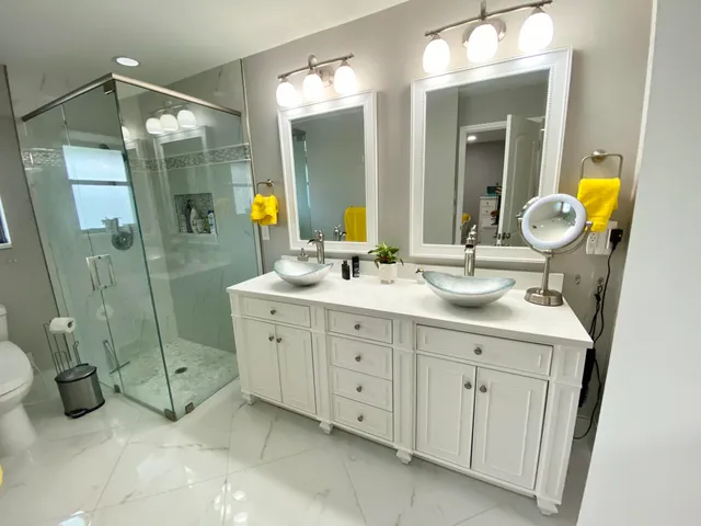 a spacious bathroom with double sink and a mirror