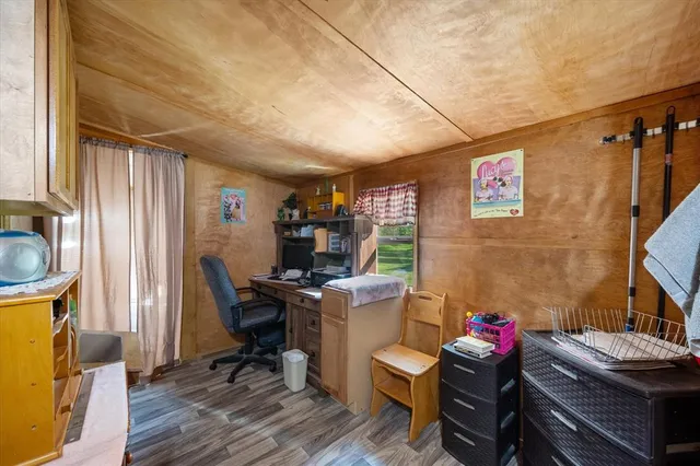 a view of a workspace with furniture and a window