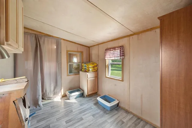 a view of room with window and wooden floor