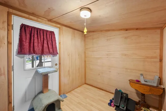 a view of a room with wooden floor and windows