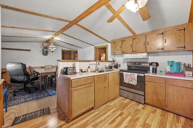 a kitchen with cabinets a sink and appliances