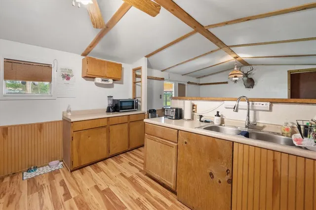 a kitchen with a sink cabinets and window
