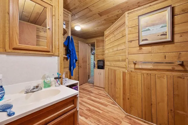 a view of walk in closet with wooden floor