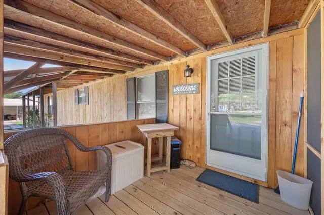 a balcony with furniture and wooden floor