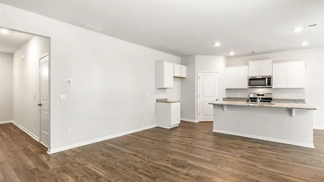 a kitchen with stainless steel appliances a refrigerator and a stove top oven