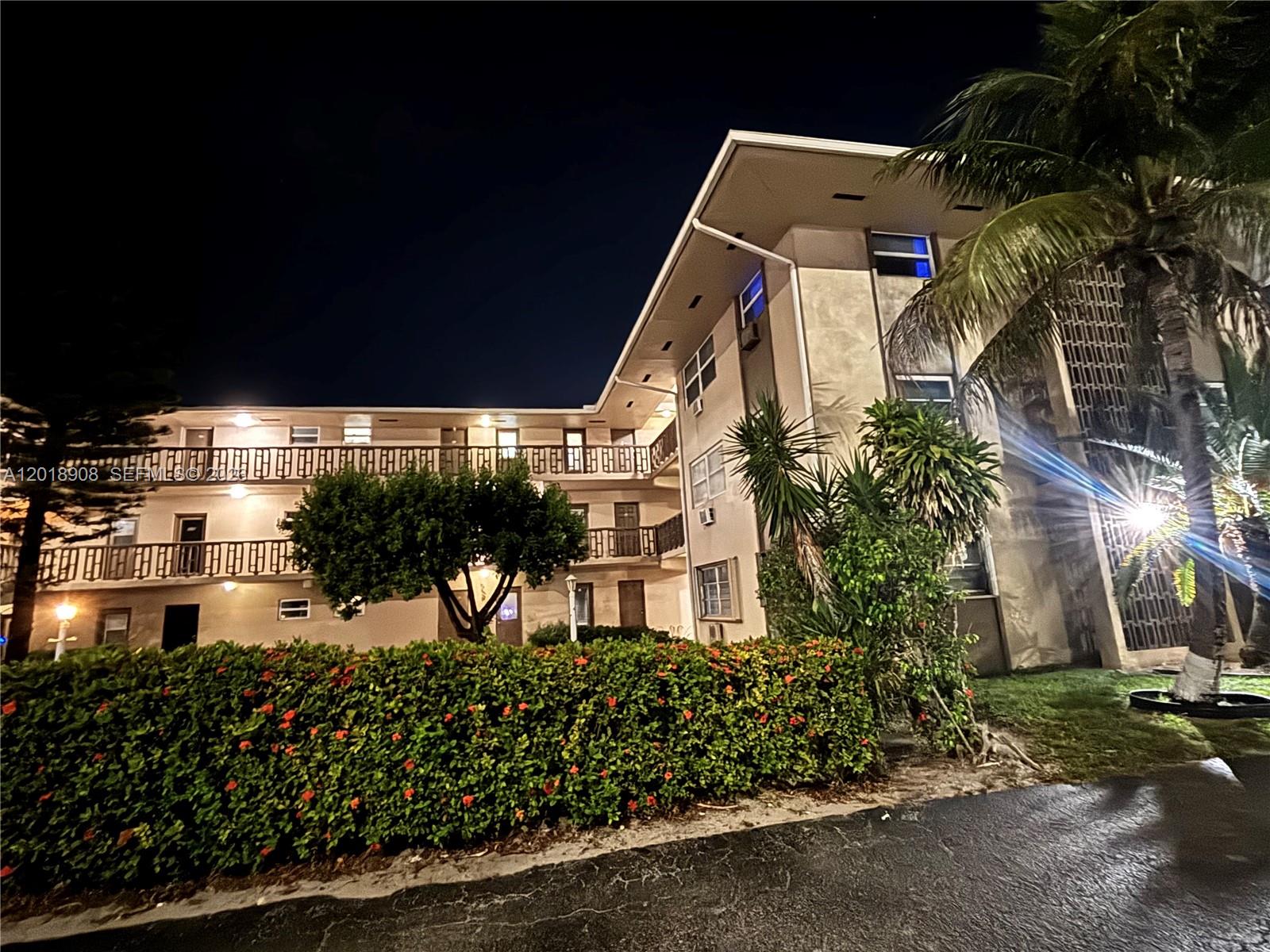 1480 East Sample Road, Unit 209 Pompano Beach, FL 33064 - Photo 23 of 24 a front view of a house with a yard