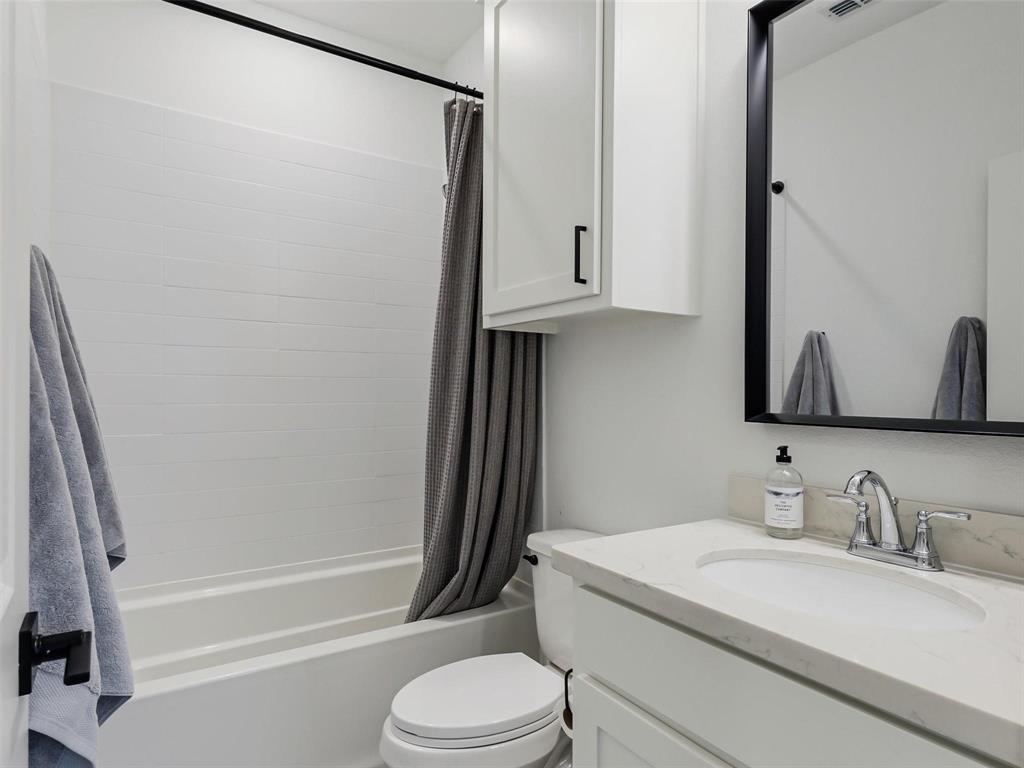 5912 Ridgeline Drive McKinney, TX 75070 - Photo 15 of 22 a bathroom with a granite countertop sink toilet and shower