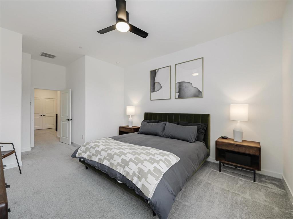 5912 Ridgeline Drive McKinney, TX 75070 - Photo 19 of 22 a bedroom with a bed and a chandelier