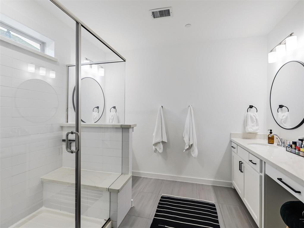 5912 Ridgeline Drive McKinney, TX 75070 - Photo 20 of 22 a bathroom with a sink a mirror and a shower