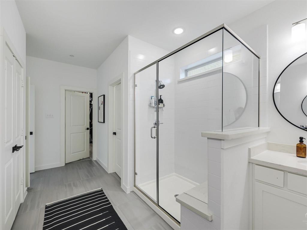 5912 Ridgeline Drive McKinney, TX 75070 - Photo 21 of 22 a bathroom with a glass shower door and a sink