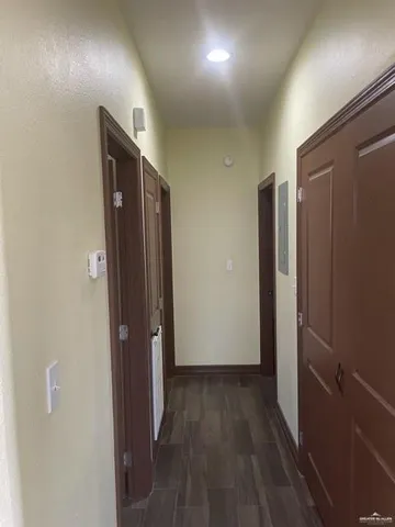 a view of hallway with wooden floor