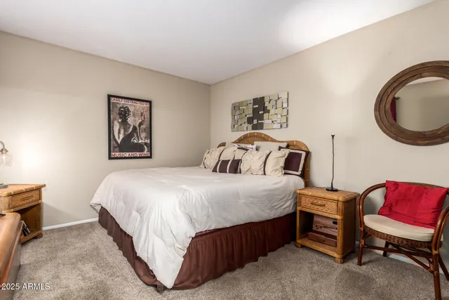 a bedroom with a bed a couch and dresser