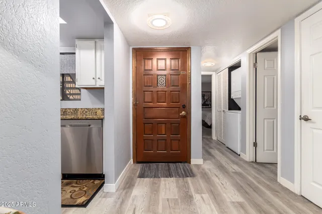 a view of hallway with stairs and wooden floor