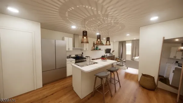 a kitchen with stainless steel appliances a refrigerator a sink dishwasher a stove with wooden floor and cabinets