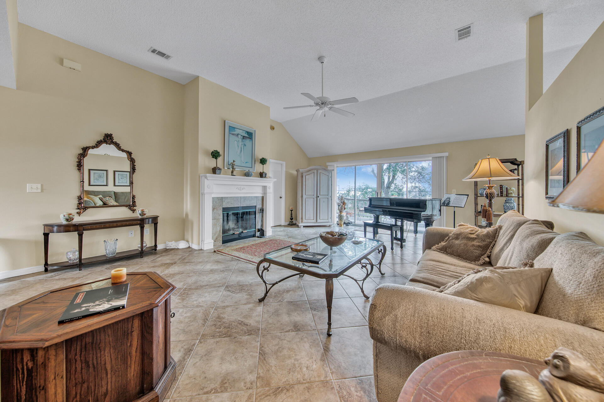 a living room with furniture kitchen view and a fireplace