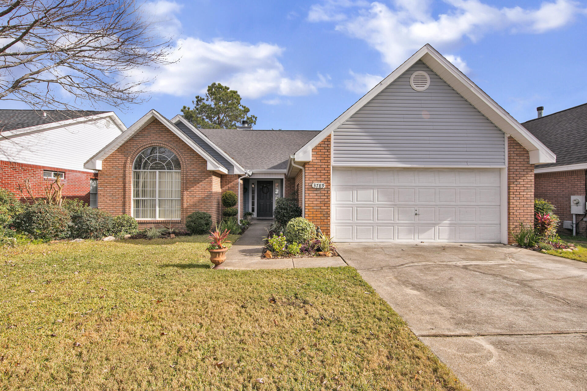 3789 Misty Way Destin, FL 32541 - Photo 2 of 29 a front view of a house with a yard