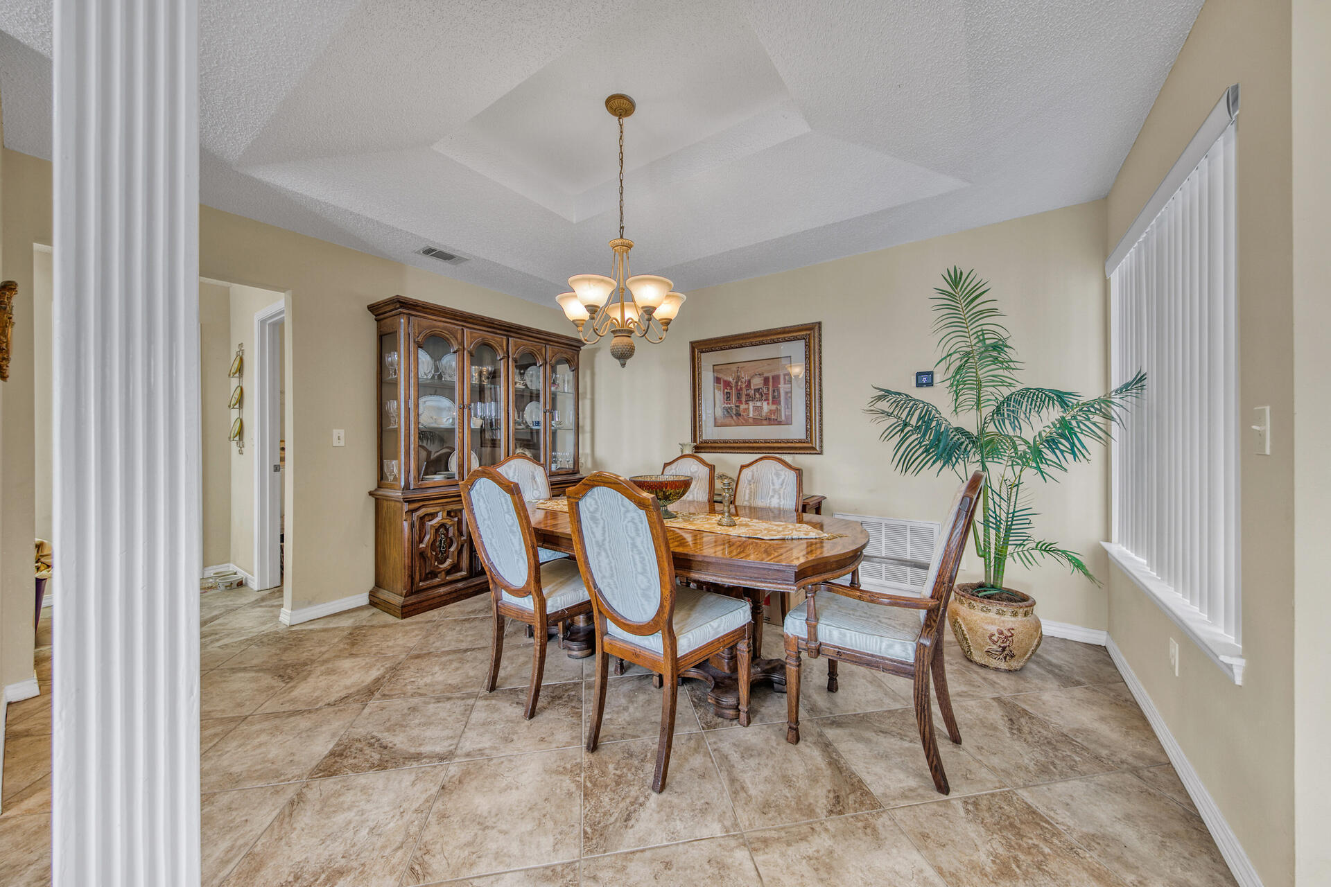 3789 Misty Way Destin, FL 32541 - Photo 15 of 29 a dining room with furniture potted plants and a chandelier