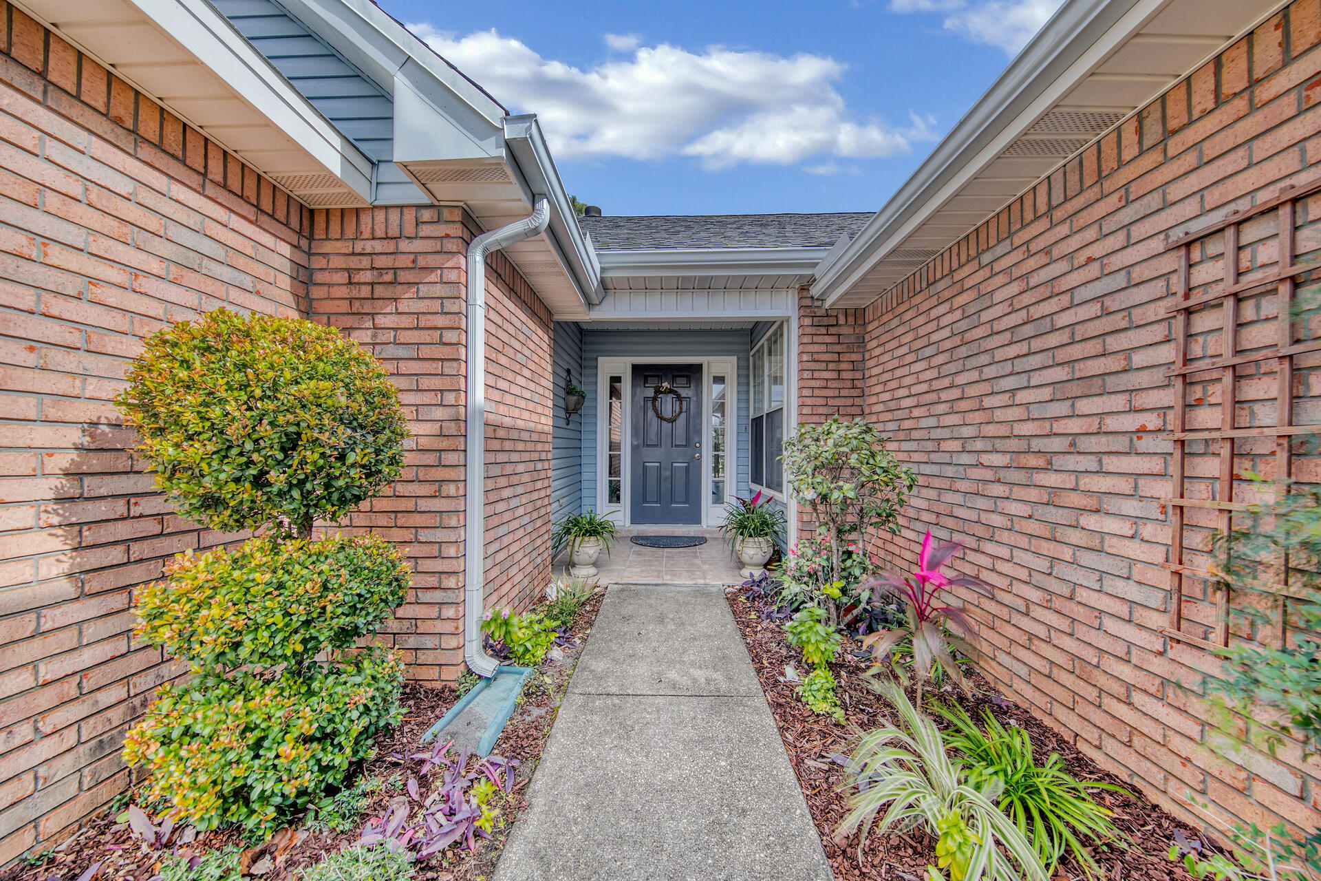 3789 Misty Way Destin, FL 32541 - Photo 4 of 29 a view of a pathway with flower pots