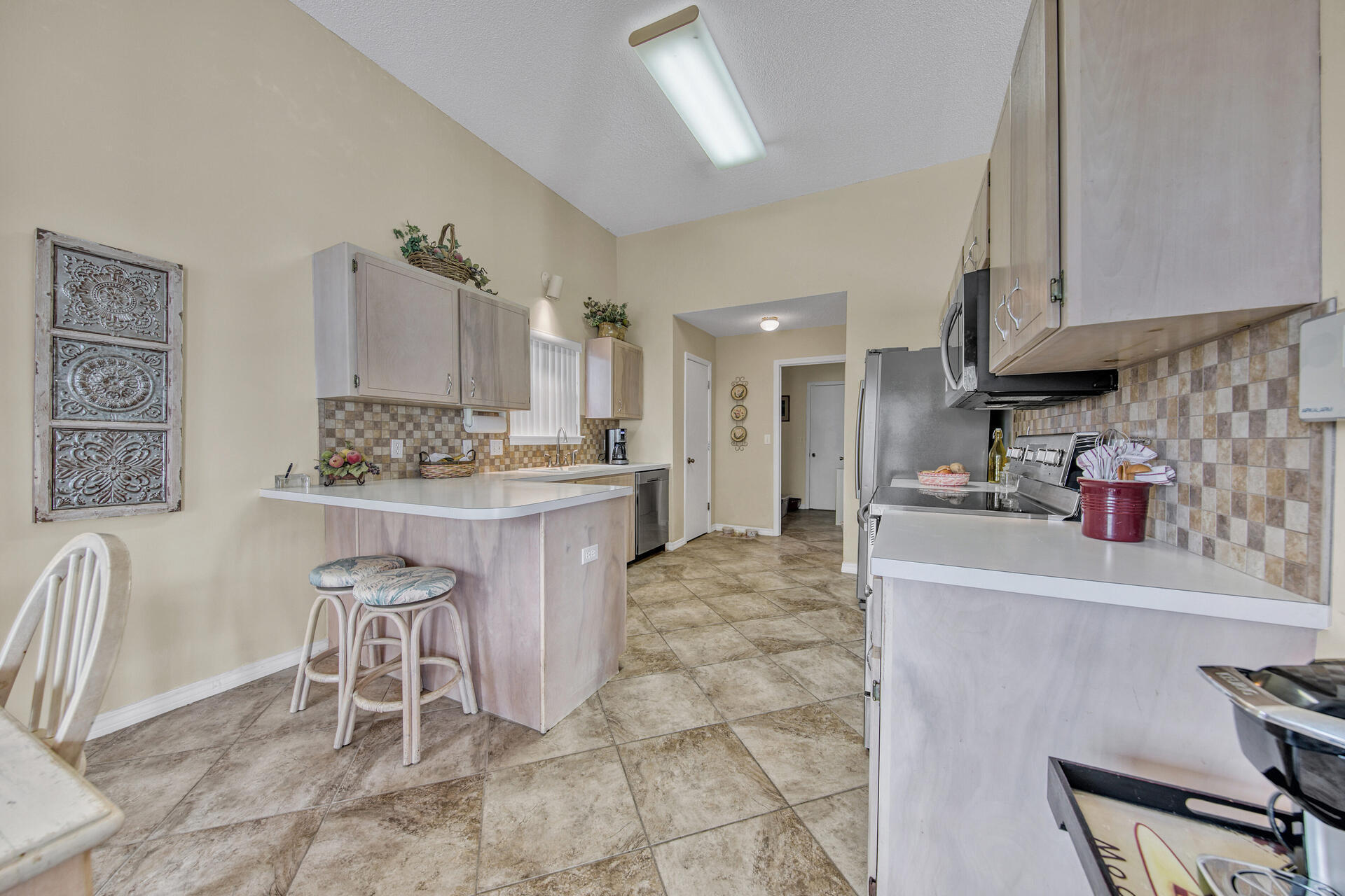 3789 Misty Way Destin, FL 32541 - Photo 10 of 29 a kitchen with stainless steel appliances kitchen island granite countertop a sink and cabinets
