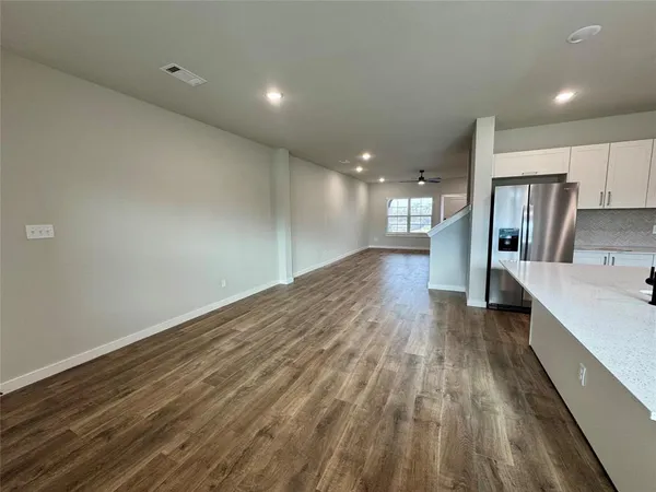 a view of a kitchen with wooden floor