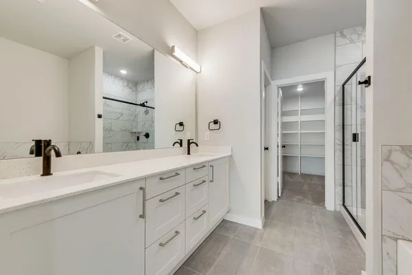 a bathroom with a double vanity sink and mirror