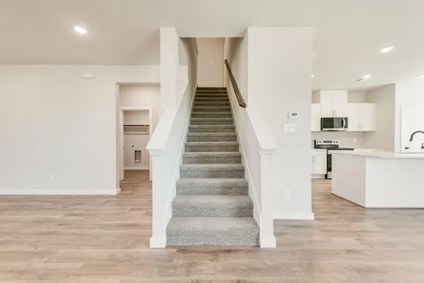 a view of kitchen with sink and wooden floor