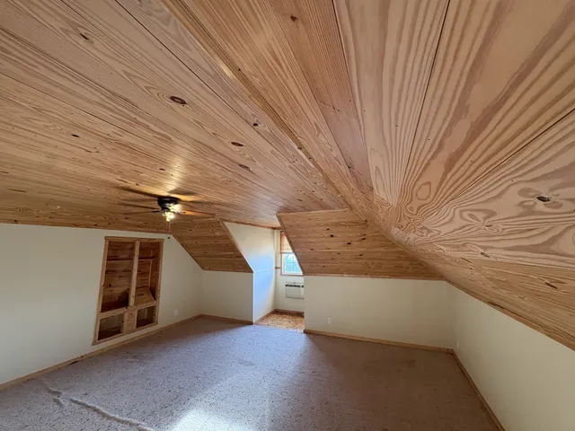 a view of a big room with wooden walls