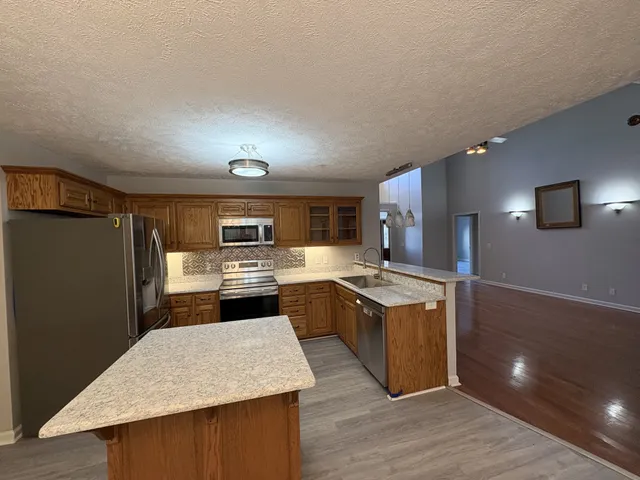 a kitchen with a stove a refrigerator and a sink