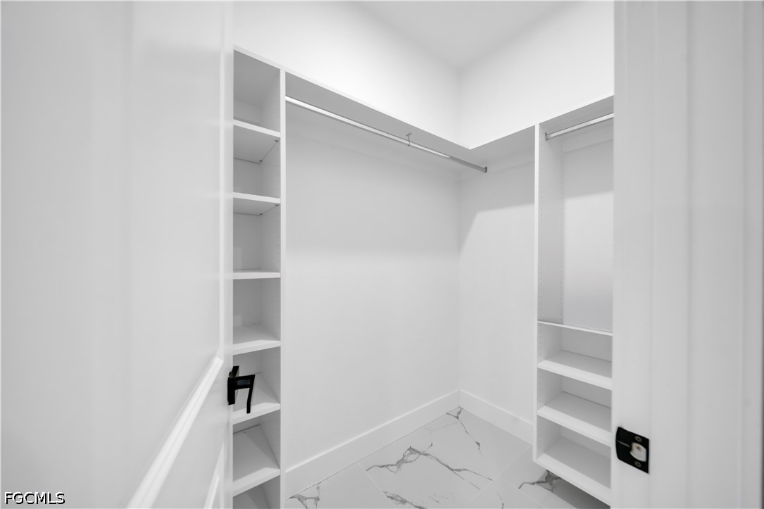 1128 Nelson Road North Cape Coral, FL 33993 - Photo 15 of 22 a view of walk in closet with empty racks