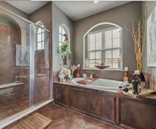 a bathroom with double vanity and a mirror