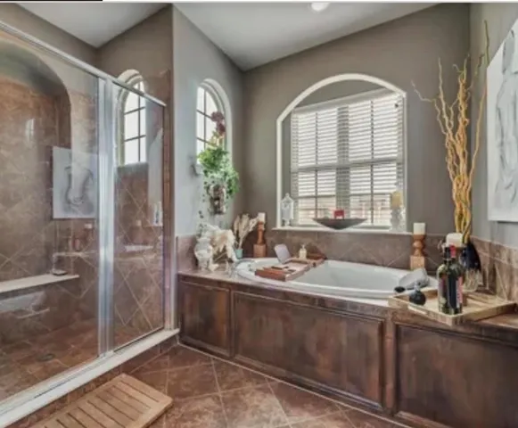 a bathroom with double vanity and a mirror