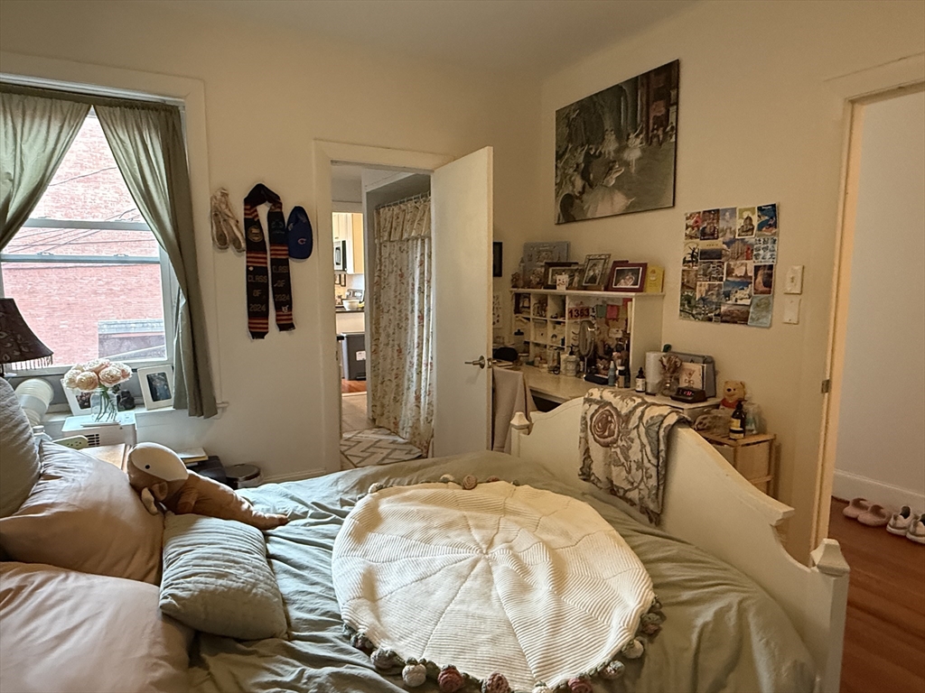 1871 Beacon Street, Unit 4 Brookline, MA 02445 - Photo 5 of 14 a bed sitting in a bedroom next to a window