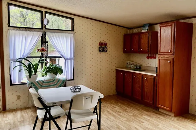 a kitchen with a table chairs and refrigerator
