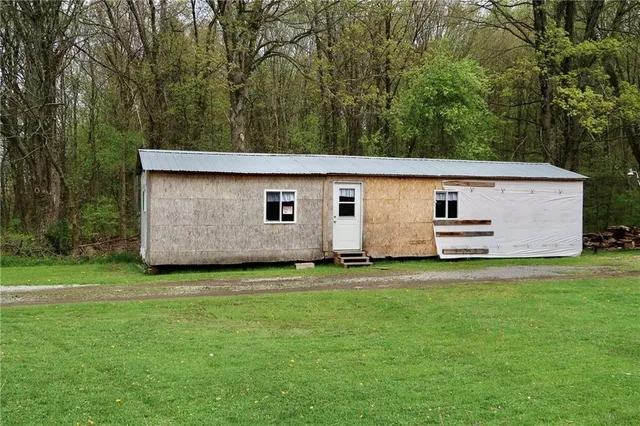 a backyard of a house with barbeque oven