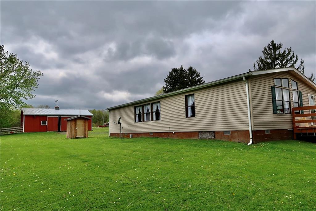 78 Balut Road Fredonia, PA 16124 - Photo 27 of 29 a big white house with a yard and wooden fence
