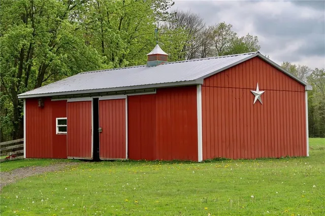 a view of a house with a yard and sitting area