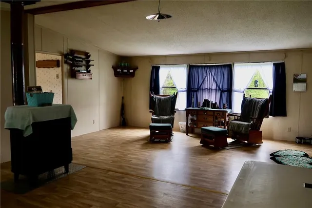 a view of a livingroom with workspace and a window