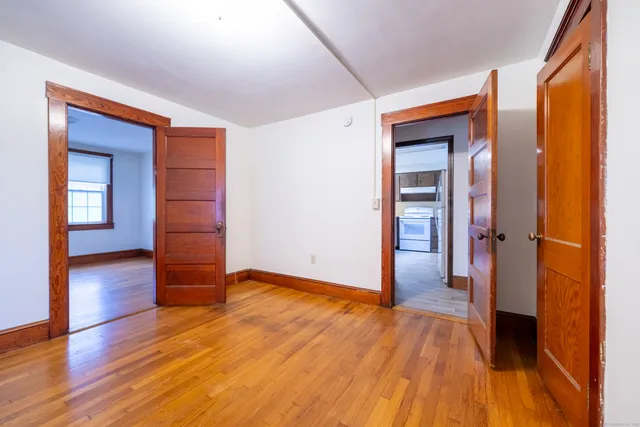 wooden floor in an empty room with a window