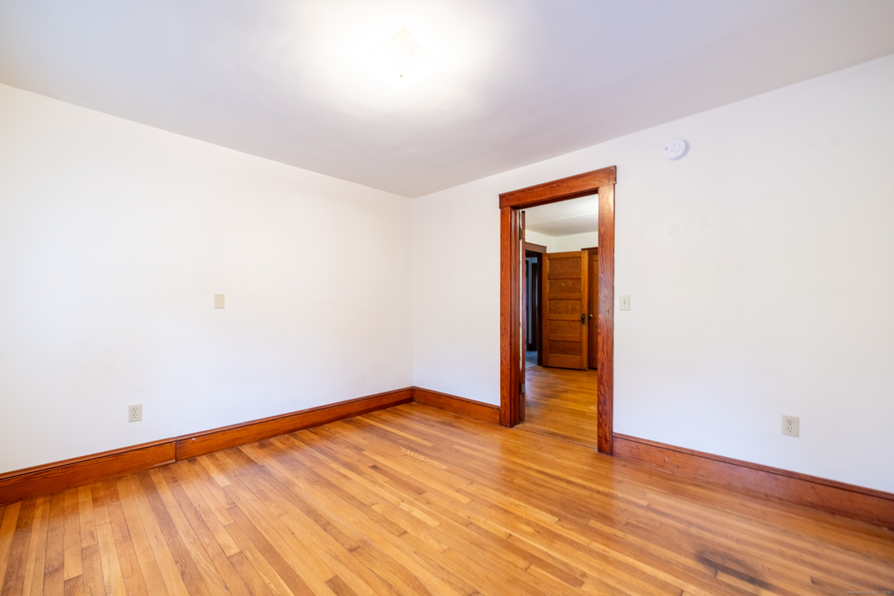 23 Waldo Road Norwich, CT 06360 - Photo 14 of 26 an empty room with wooden floor and closet