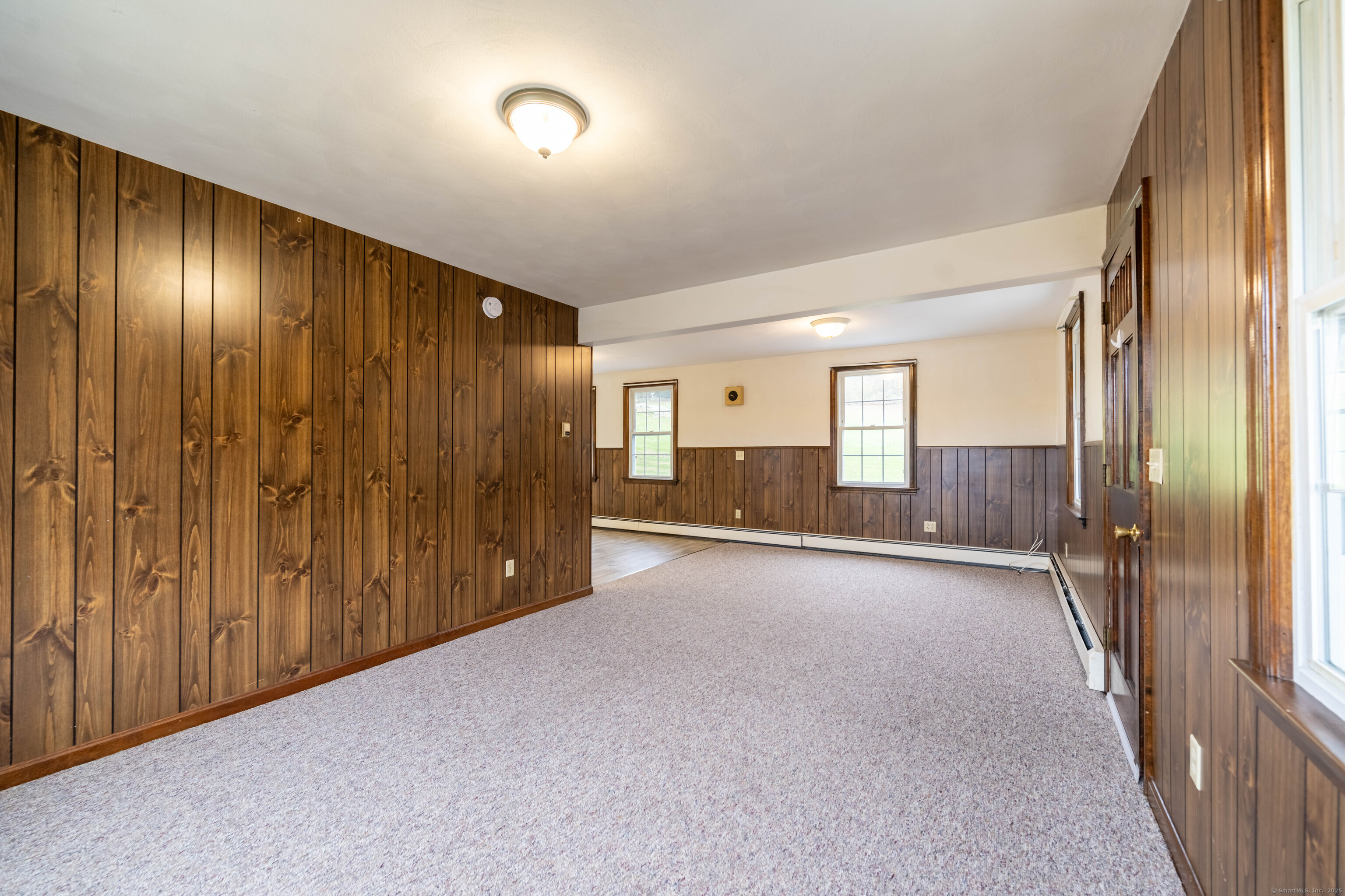 23 Waldo Road Norwich, CT 06360 - Photo 7 of 26 a view of a hallway with wooden shelves