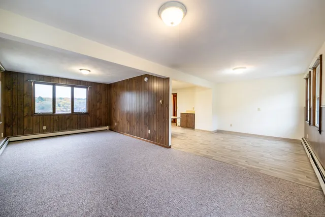 an empty room with a empty space and windows