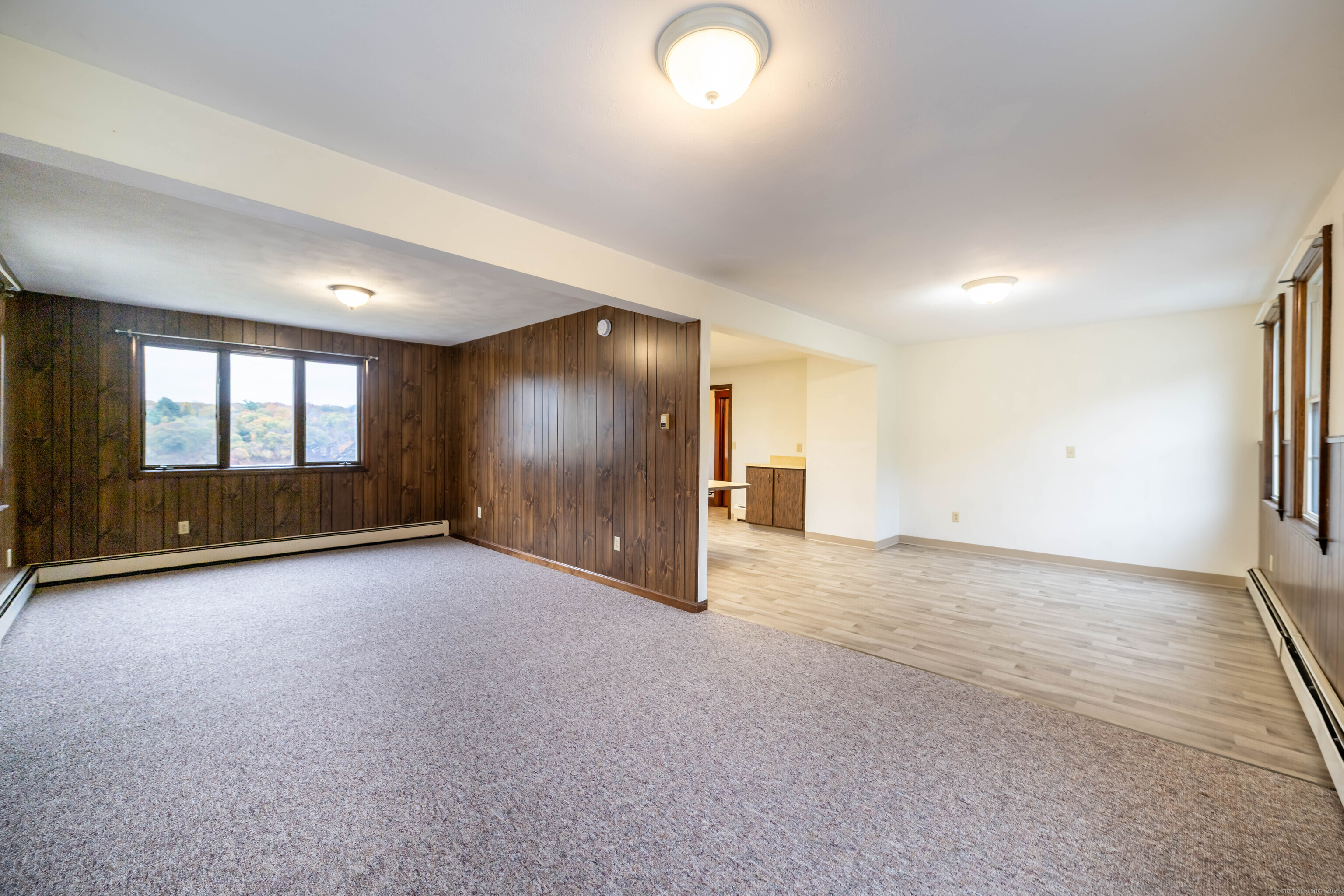 23 Waldo Road Norwich, CT 06360 - Photo 8 of 26 an empty room with a empty space and windows