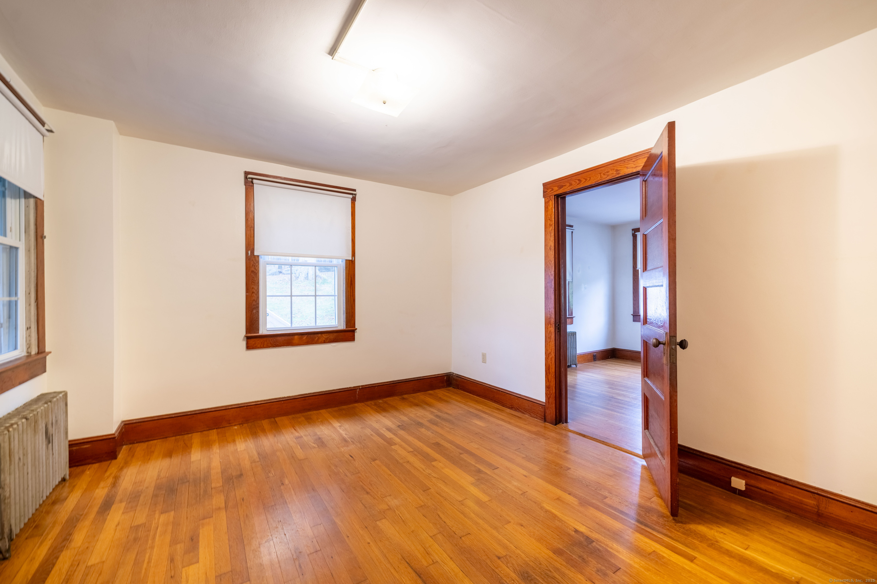 23 Waldo Road Norwich, CT 06360 - Photo 10 of 26 wooden floor in an empty room with a window