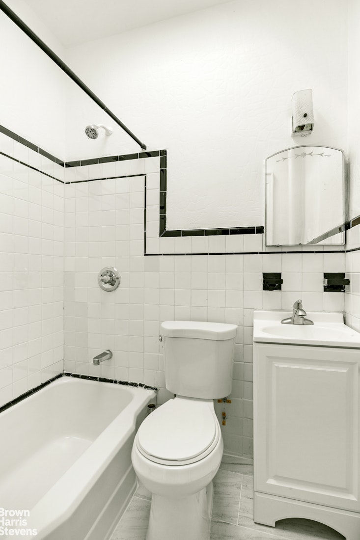 100 Newel Street, Unit 4L Brooklyn, NY 11222 - Photo 10 of 13 a bathroom with a sink a toilet and shower