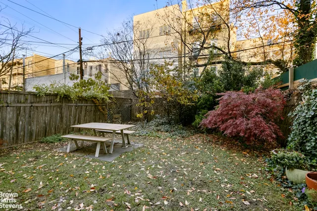 a backyard of a house with table and chairs
