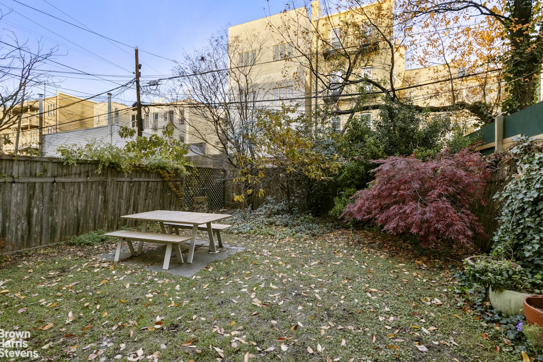 100 Newel Street, Unit 4L Brooklyn, NY 11222 - Photo 11 of 13 a backyard of a house with table and chairs
