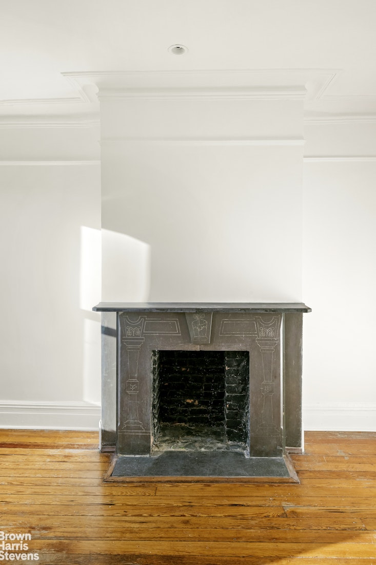 100 Newel Street, Unit 4L Brooklyn, NY 11222 - Photo 9 of 13 a view of empty room with wooden floor and fireplace